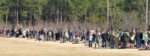 Photo courtesy of Sharon T. Bass. Family members, fellow soldiers, and others place wreaths on each of the trees, then pause to reflect on the sacrifice. Warrriors Walk Wreath Ceremony - Placing the Wreaths
